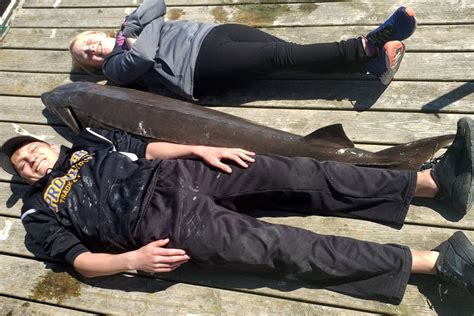 Minnesota teen lands monster sturgeon while fishing from dock
